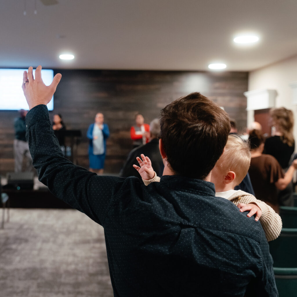 Child Worshipping with Family at New Life Pentecostal Church